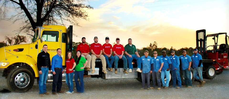 Interstate Building Materials Crew Gathered about Truck